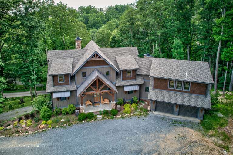 Grand timber-frame entrance and wooded setting at Triple Bear Lodge At Eagles Nest, your Blue Ridge mountain retreat for groups up to 20.