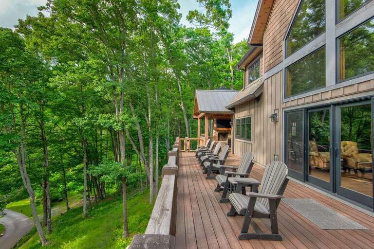 Spread out on the expansive uncovered deck at Triple Bear Lodge At Eagles Nest, where Adirondack chairs and wooded surroundings set the scene for easy mountain mornings.