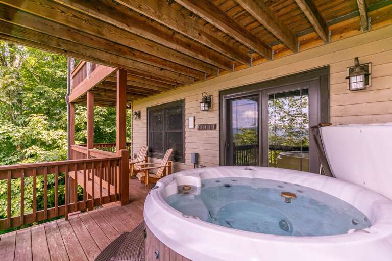 Vacation Rental Balcony With Hot Tub, Leafy Views, And Wooden Furniture