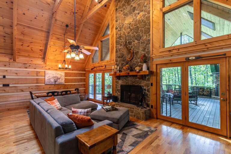 Rustic Rental Retreat With Soaring Ceilings, Stone Fireplace, And Forest-facing Deck