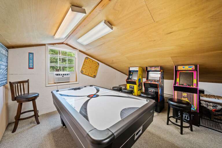 Attic Arcade Area With Air Hockey And Arcade Machines In A Vacation Rental