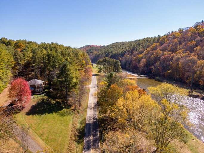 Aerial View Of Vivid Valley With River And Road