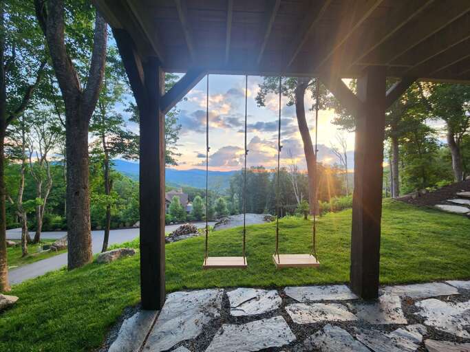 Sunset Swings Under Stone Shelter, Serene Sky Scene