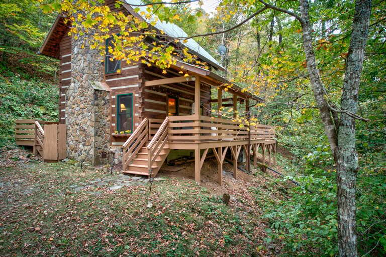 Rustic Cabin Nestled In Nature, Flanked By Fall Foliage