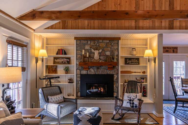 Rustic Room With Roaring Fire, Wooden Beams, And Vintage Furnishings, Ideal For Vacation Rental Relaxation