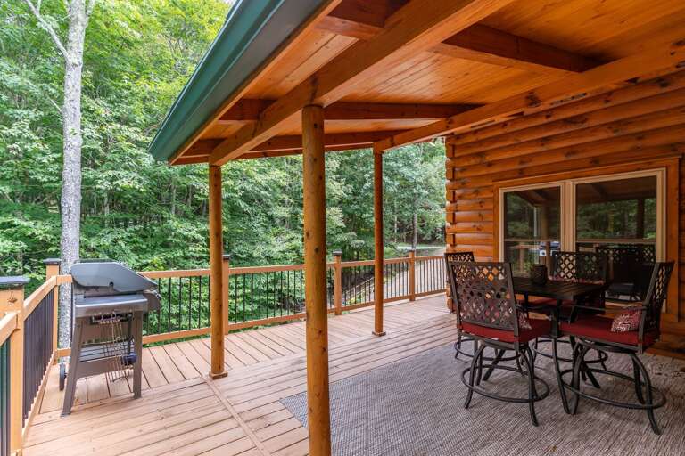 Wooden Cabin Deck With Dining Set In Dense Forest Setting