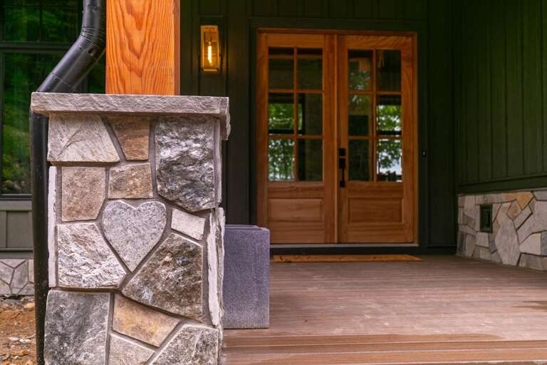 Stone-clad Steps Leading To A Wooden Door Of A Vacation Rental