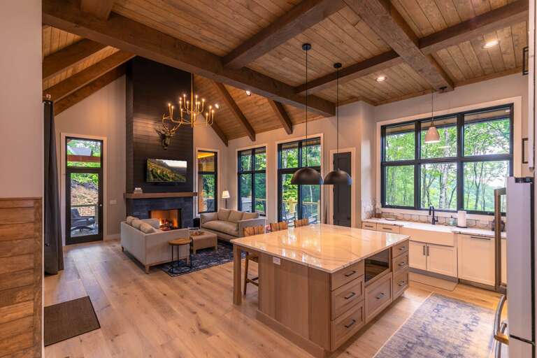 Spacious Kitchen And Living Space With High Ceilings And Large Windows