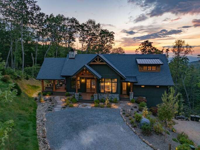 Nestled into the ridgeline above Blowing Rock, The Heartstone Lodge At Eagles Nest sits surrounded by hardwoods with mountain layers stretching to the horizon.