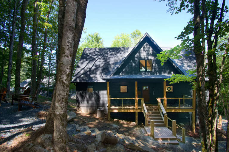 Nicely landscaped steps up to the firepit from the front entryway