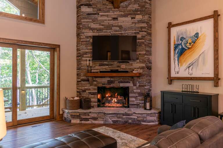 Rustic Room With Roaring Fireplace And Forest-facing Doors In A Vacation Rental