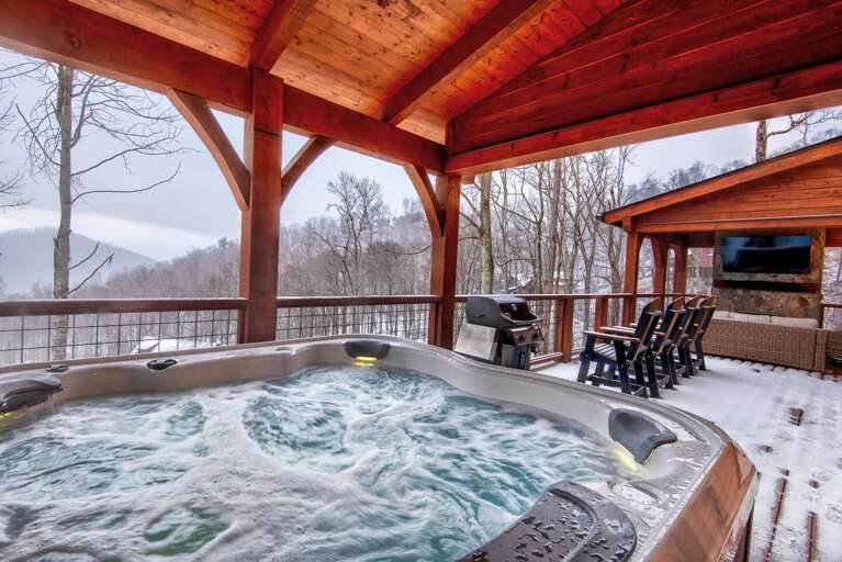 Snow-dusted Deck With Steaming Outdoor Jacuzzi Overlooking Wintry Woods