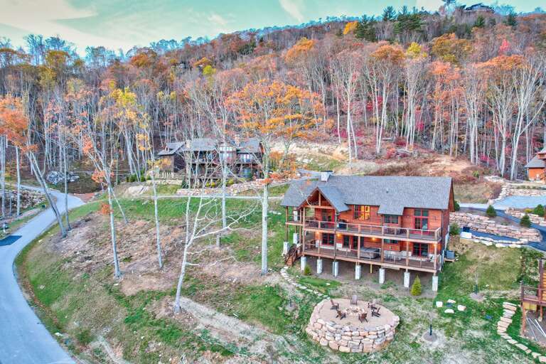 Aerial View Of Rustic Red House Nestled Among Autumnal Trees