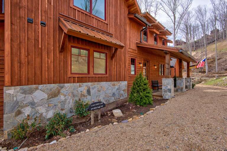 Vacation Rental View With Verdant Vistas, Featuring A Stone And Timber Facade