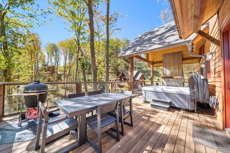 Wooden Deck With Table, Chairs, And Hot Tub Surrounded By Trees