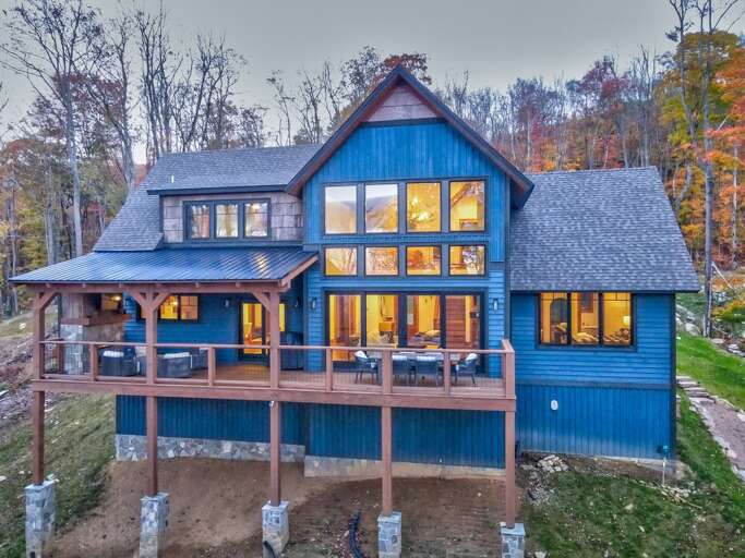 Blue Vacation Rental Amidst Autumnal Trees, Twilight Time Illumination Visible