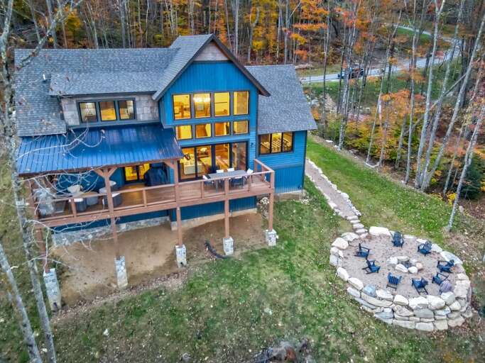 Vacation Rental Nestled In Nature, Featuring Vivid Windows And A Vibrant Veranda