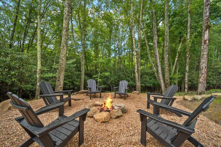 Gather around the fire under the trees. This gravel fire pit circle at Bull & Bear At Eagles Nest is ready for s'mores and starlit stories.