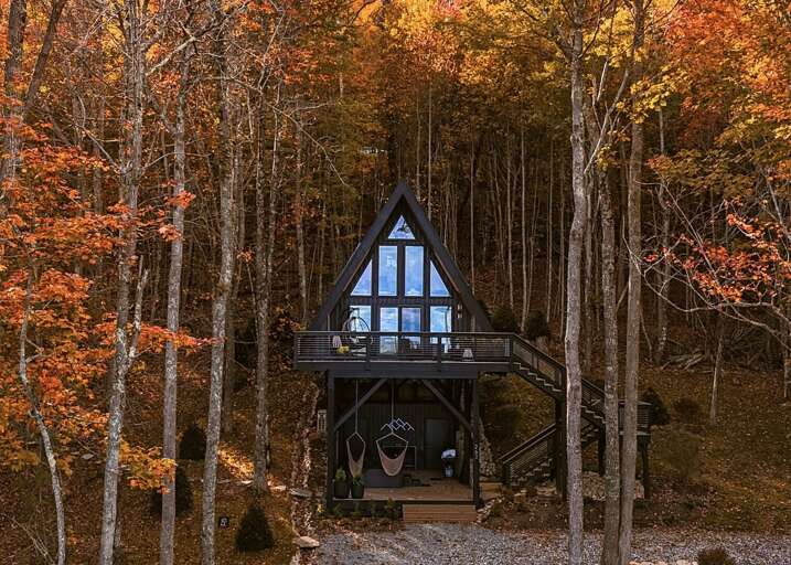 Tucked into the trees above Boone, this striking A-frame welcomes you with a soaring glass facade and a shaded lower patio with a hot tub.