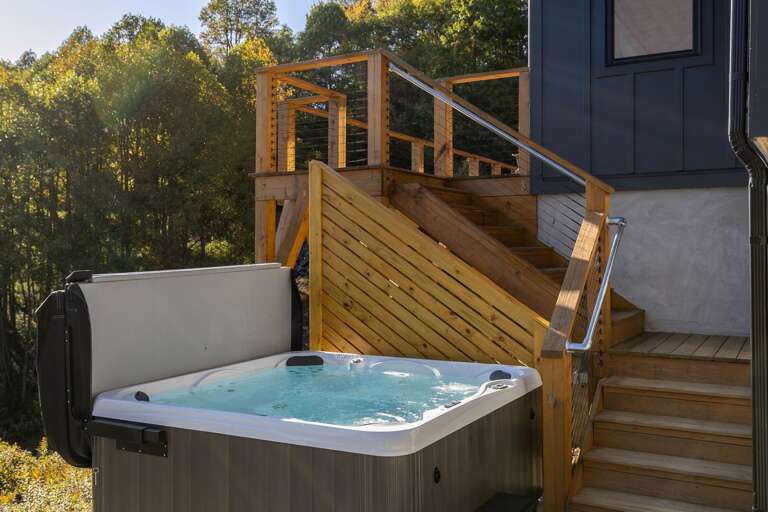 Wooden Walkway Leading To Bubbling Jacuzzi Outside Building