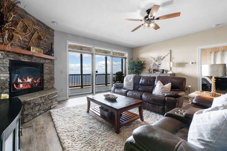 Living Room With Lake View, Light Leather Lounge, Lit Fireplace