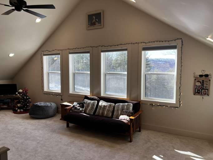 Attic Area With Ample Window Array, Plush Sofa Set, Ceiling Fan