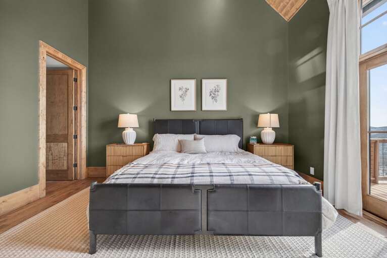 Wake up to mountain views and warm afternoon light streaming through the French doors. Vaulted wood ceilings add a cozy cabin feel.