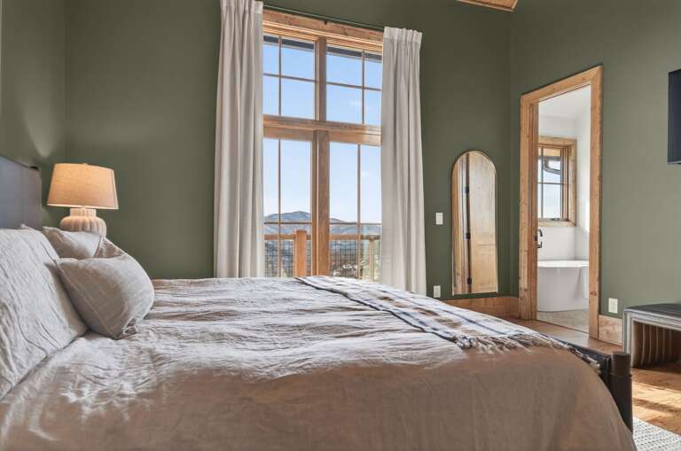 Wake up to mountain views and warm afternoon light streaming through the French doors. Vaulted wood ceilings add a cozy cabin feel.