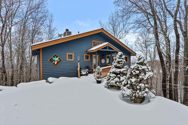 Blue Building Blanketed By Snowy Scenery, Serene Sky