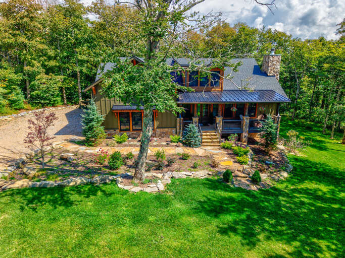 Craftsman details at every turn. Stone columns, cedar shake siding, and hanging flower baskets welcome you home in Sugar Mountain.