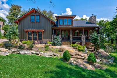 Tucked among the trees on Sugar Mountain, The Sugar Chalet welcomes you with warm wood accents, stone details, and a covered front porch.