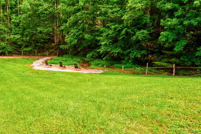 Creekside beach with a soaring fountain and the iconic red barn. Pure Blue Ridge charm.