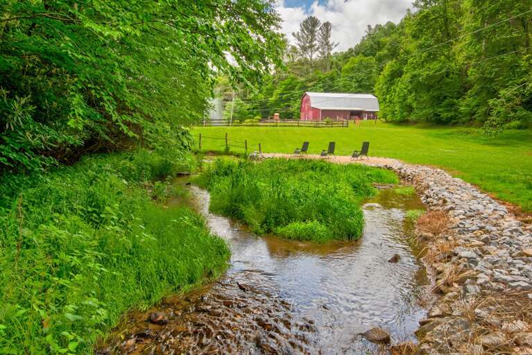 Creekside beach with a soaring fountain and the iconic red barn. Pure Blue Ridge charm.