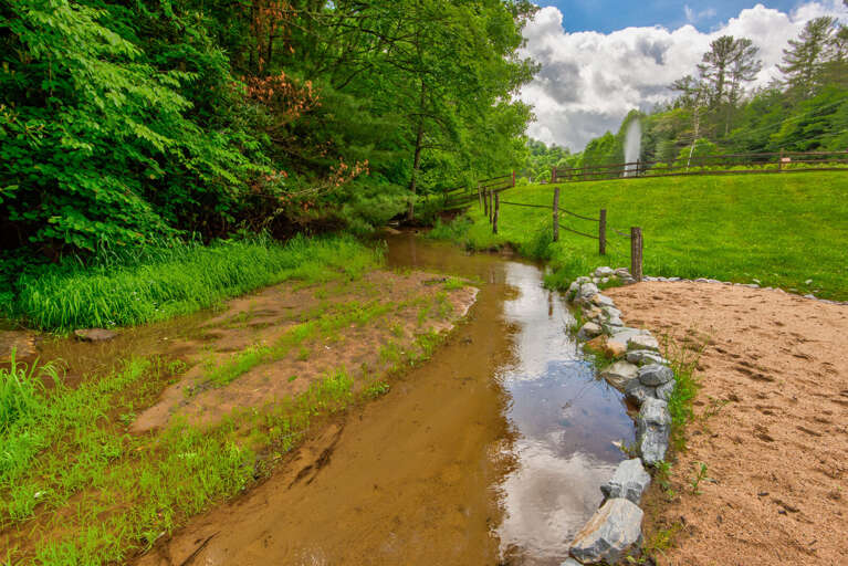 A private beach next to the creek with a soaring fountain and the iconic red barn. Pure Blue Ridge charm.