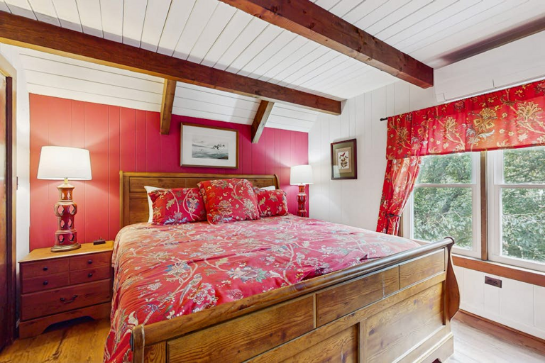 A third bedroom with a King bed and exposed beam ceilings