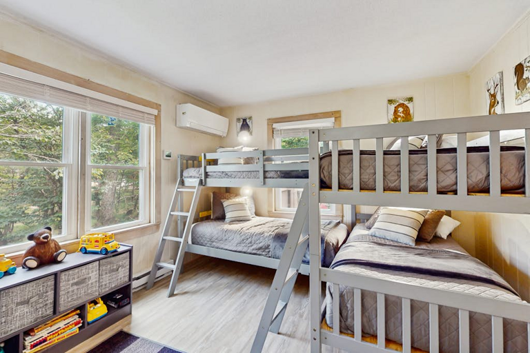 Kids of all ages will love this bunk bedroom featuring two sets of twin-over-twin bunks!
