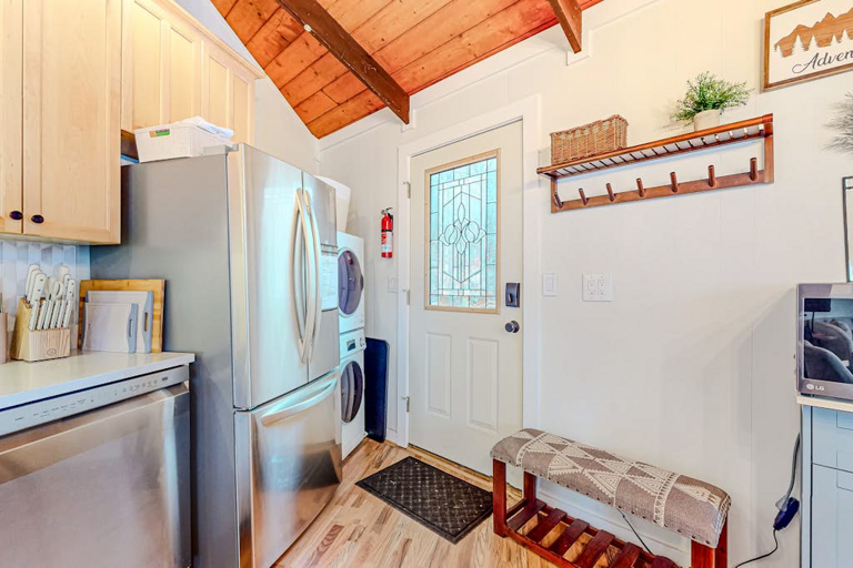 Enter the home into its heart: the kitchen, where you'll find a full size refrigerator and a stacked washer & dryer.