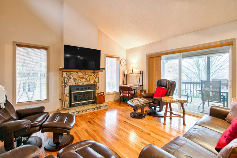 The bright, airy living room welcomes one and all to relax and unwind here in the mountains.