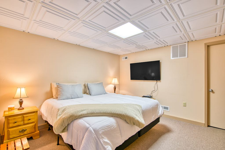 Head downstairs to find the third bedroom, with a King bed and TV.