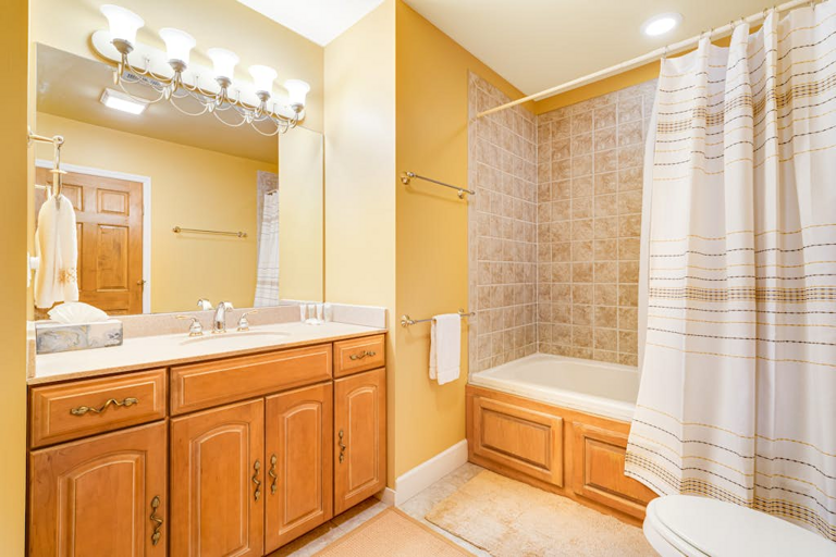 This full bathroom includes a tub and shower for an easy, comfortable morning routine.
