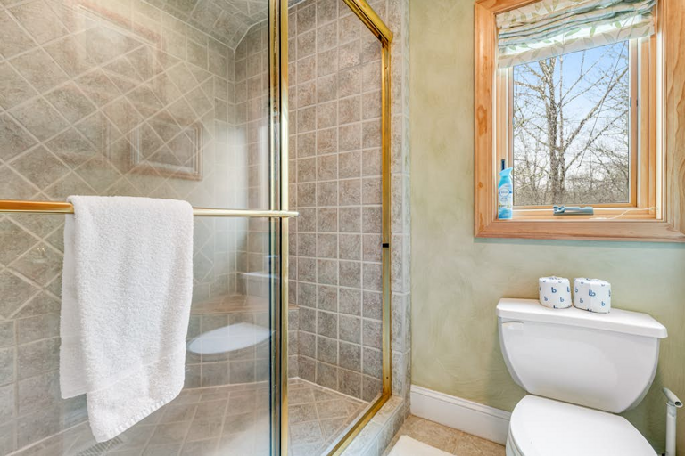 The tiled walk-in shower adds comfort and convenience to the primary bath.