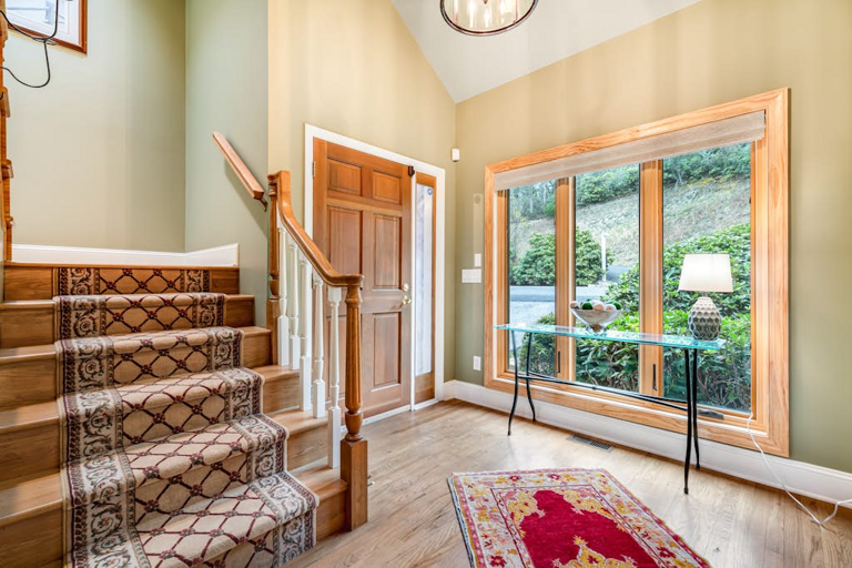 The welcoming entry brings in natural light and opens to the home's upper level.