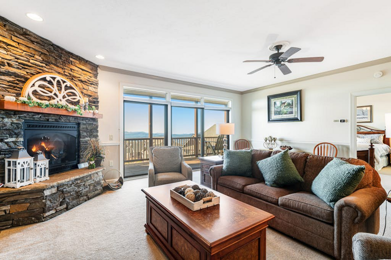 Cozy up by the stone fireplace or settle in to enjoy the beautiful view from the living room.