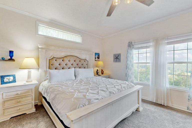 Wake up to natural light and peaceful mountain scenery from this spacious bedroom.