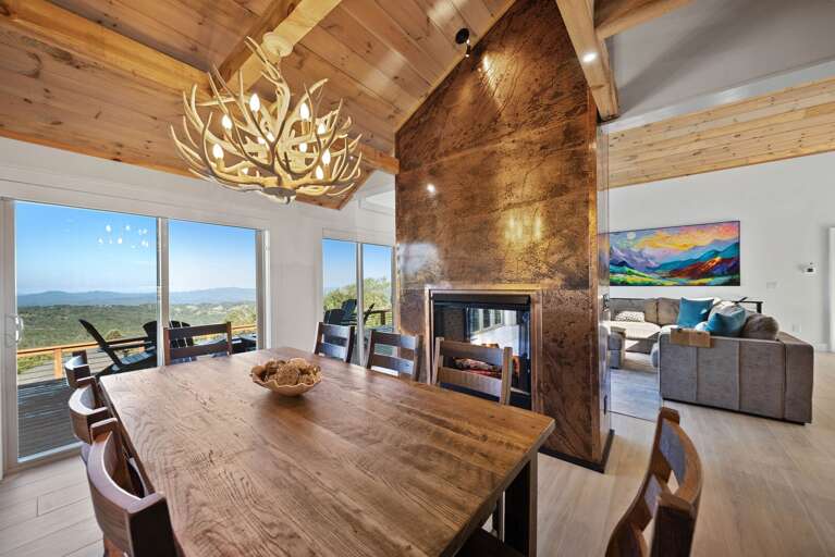Dining for 8 near towering double sided fireplace