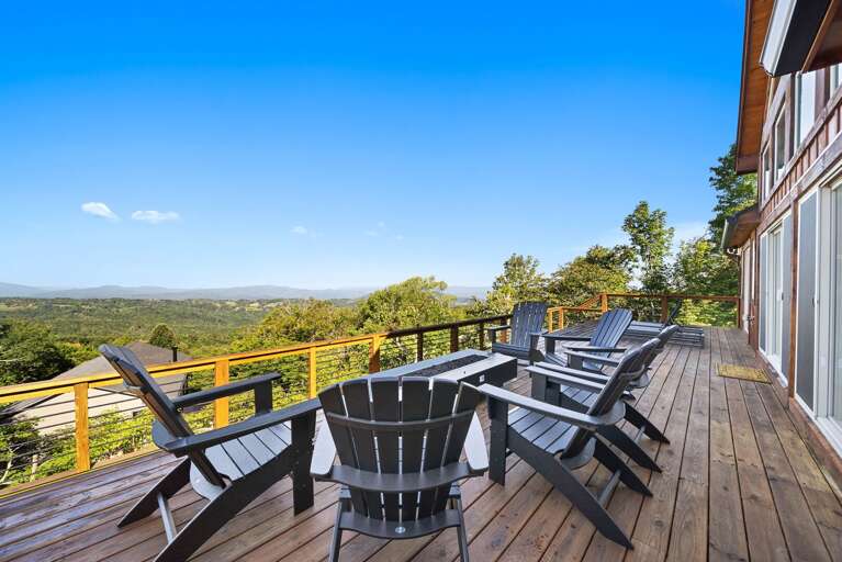 Fire table with Adirondack chairs with a view on the open deck
