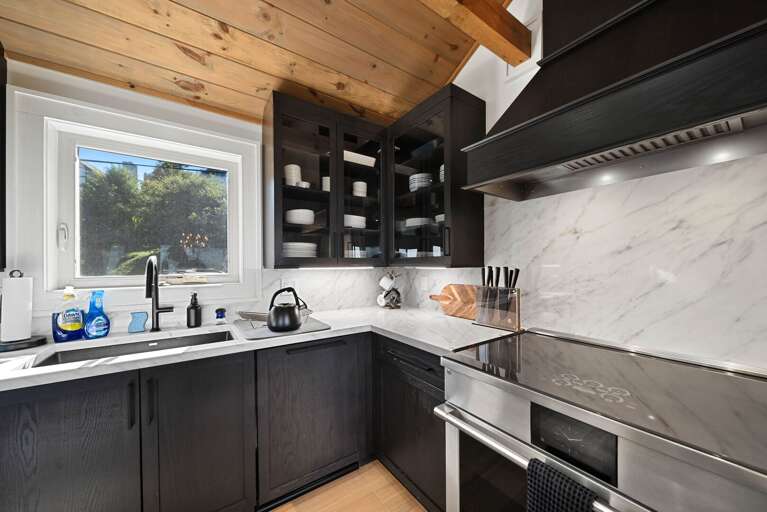 Stone counters, stainless steel, and glass cooktop