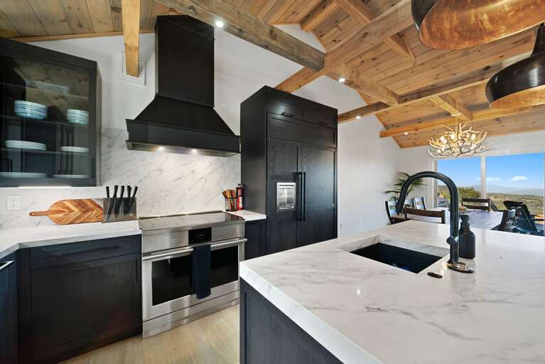 Stone counters, stainless steel, and glass cooktop