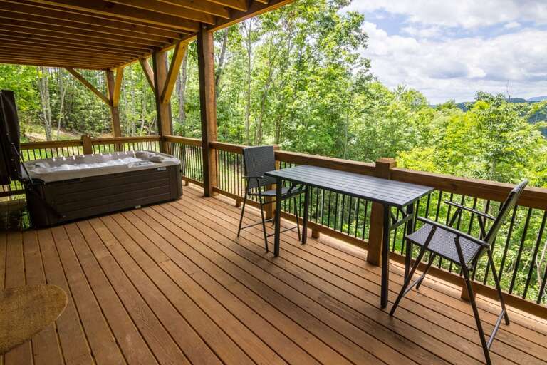 Lower level deck with table, chairs and hot tub Lower level deck with table, chairs and hot tub
