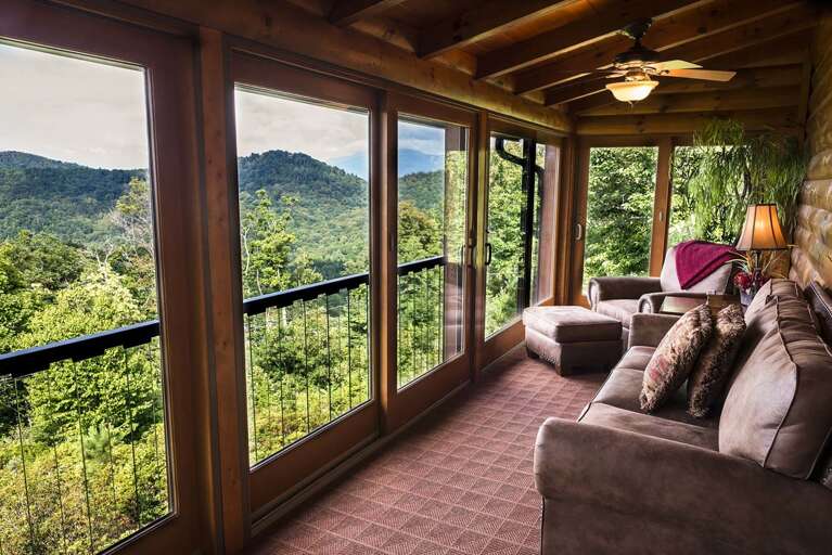 Covered, screened in porch with furnishings